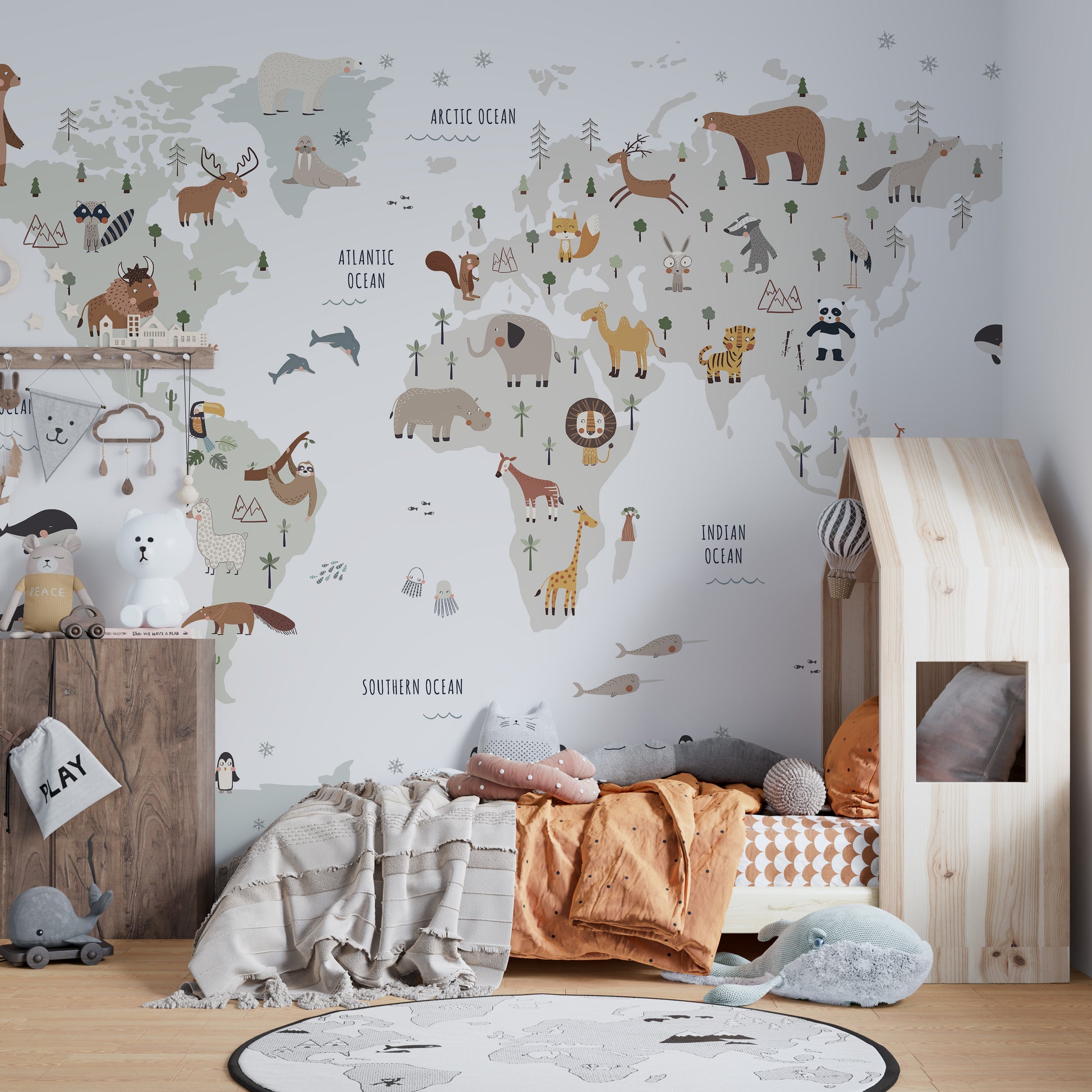 World map mural in white tones with colorful animal accents
