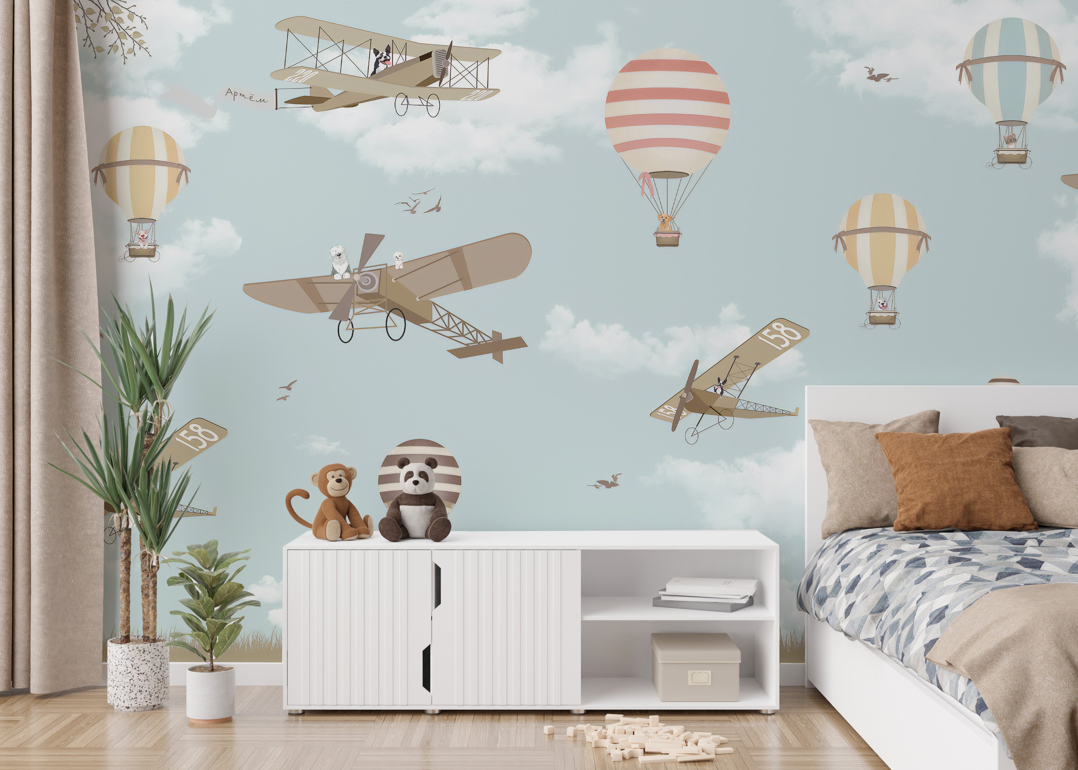 Sky-themed mural with planes and hot air balloons