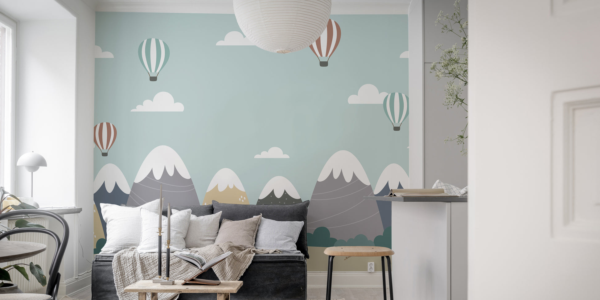 Scenic mountain mural with vibrant balloons and gentle clouds.
