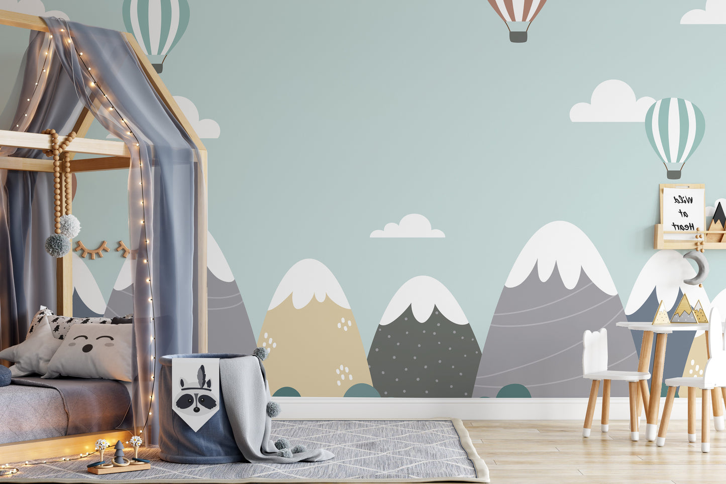 Peaceful mural of mountains, balloons, and fluffy clouds.
