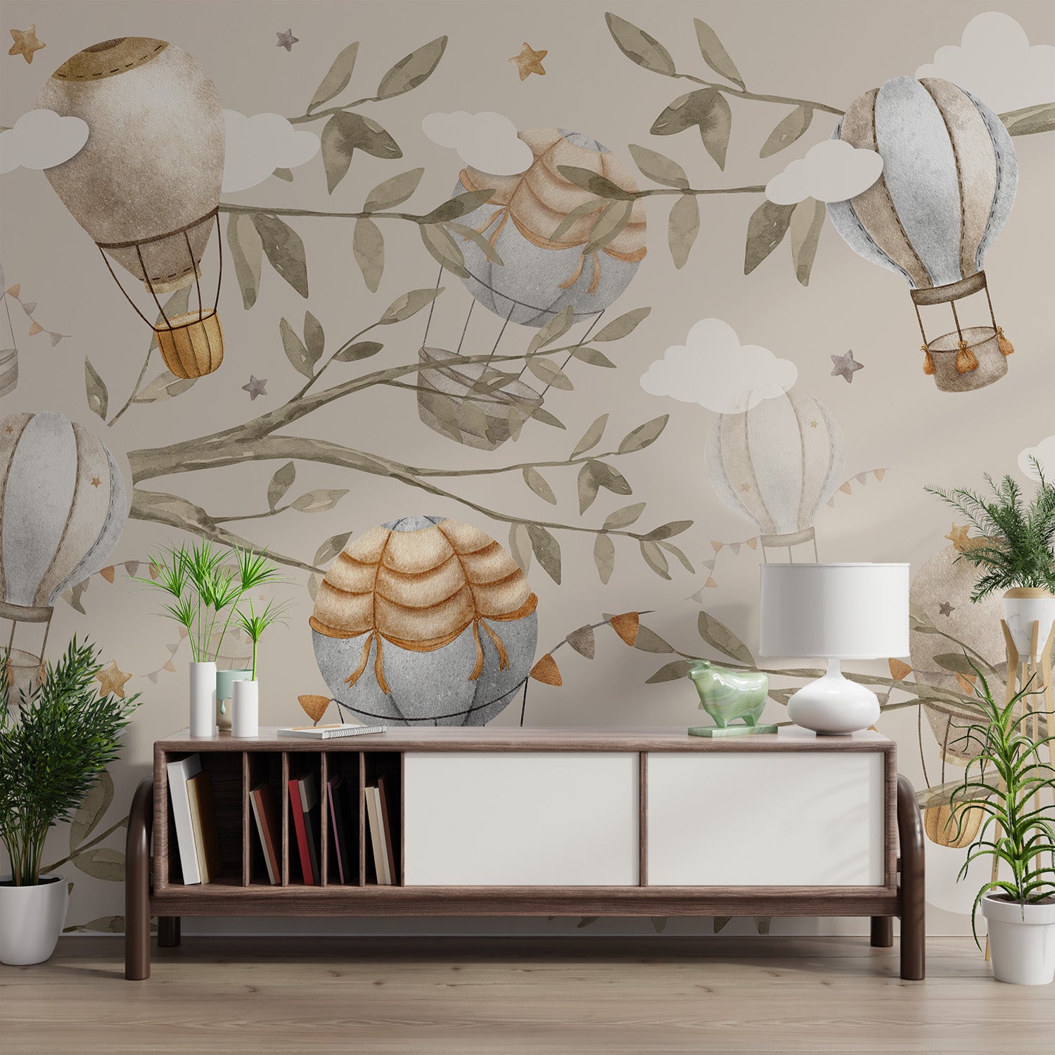 A whimsical mural with vintage hot air balloons and olive green branches against a beige backdrop.